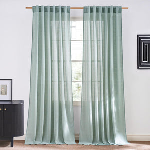 Sage green linen blend curtains with rod pocket top, hung on a wooden rod.