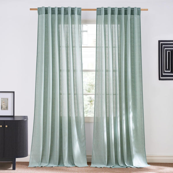 Sage green linen blend curtains with rod pocket top, hung on a wooden rod.