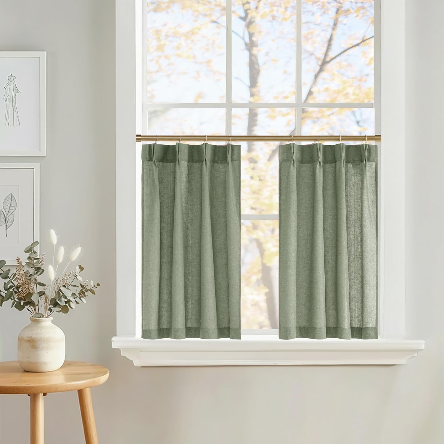 Sage green linen blend light filtering cafe curtains on a brass rod in a bright window.