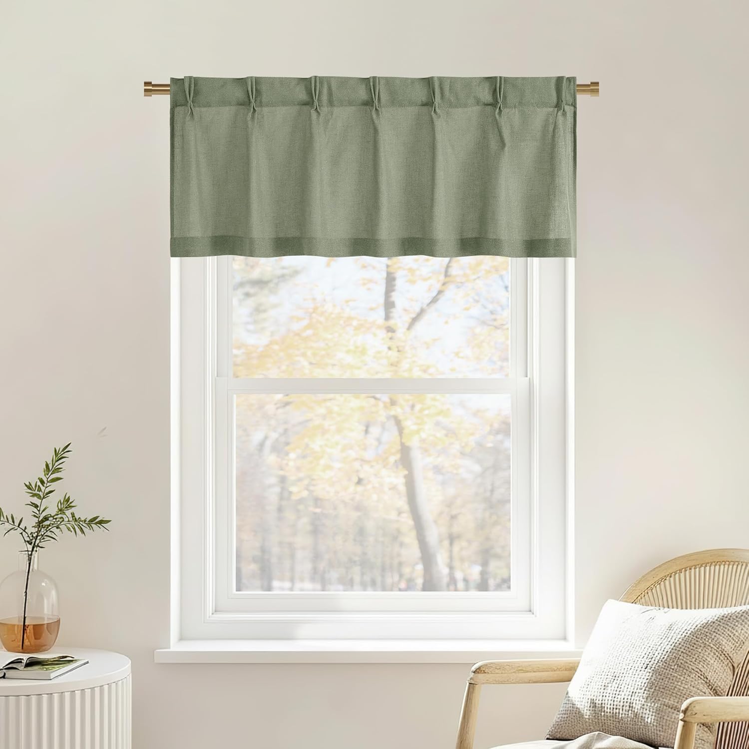 Muted sage green linen blend tie-top window valance on a brass rod, filtering light.