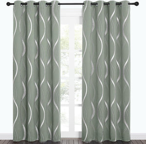Sage green curtains with metallic silver wavy pattern and grommet tops hanging on a black rod.