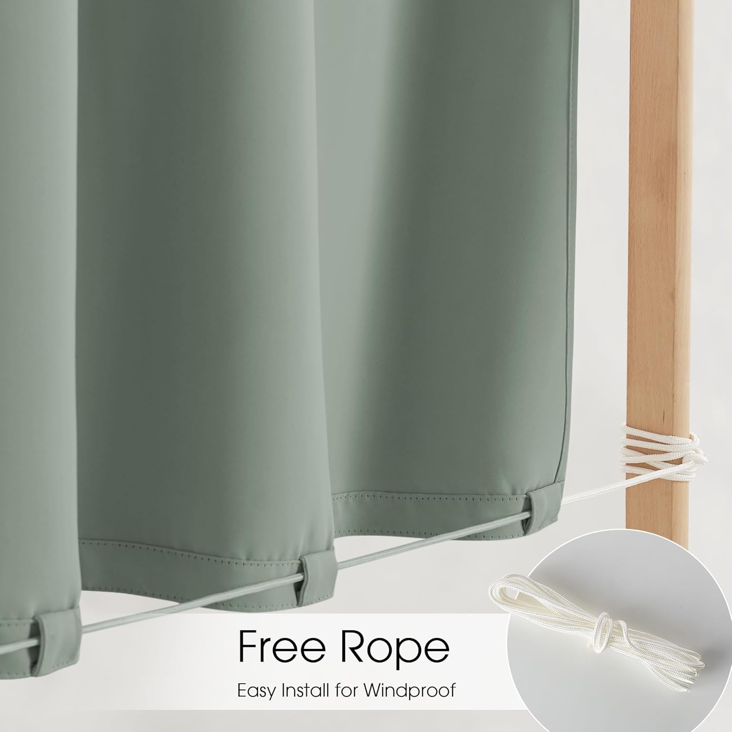 Sage green outdoor privacy panels with a white rope threaded through bottom loops for windproof installation.