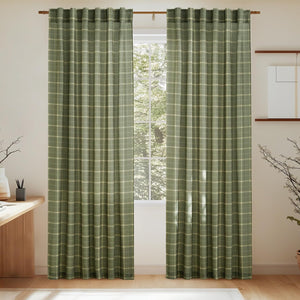 Sage green plaid curtains with cream check pattern and rod pocket top, hung on wooden rod.