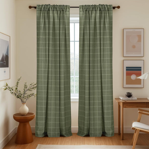 Sage green window curtains with fine plaid pattern and gathered rod pocket top, hanging in a bright interior.
