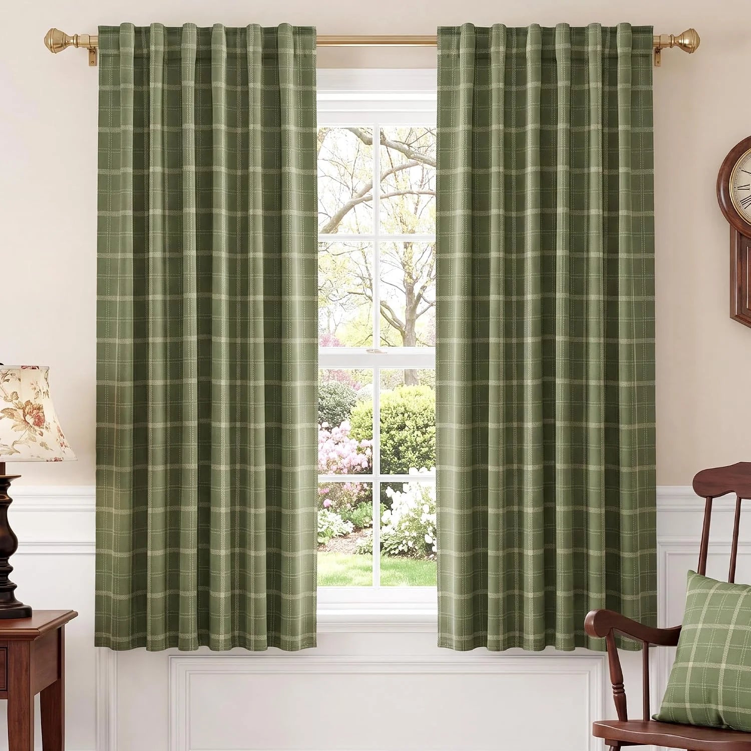 Sage green plaid curtains on a brass rod in a bright traditional room