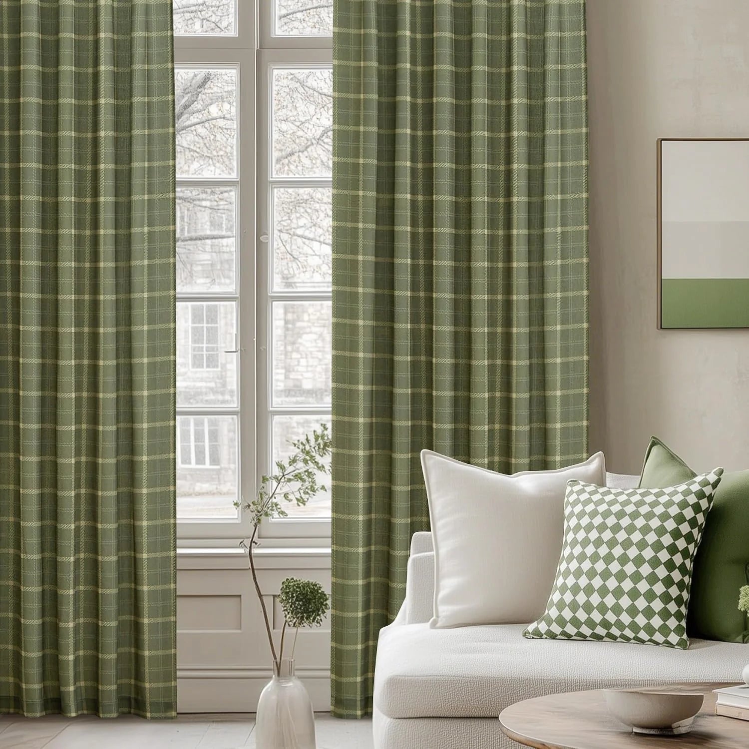 Sage green plaid curtains beside a white sofa in a bright modern living room