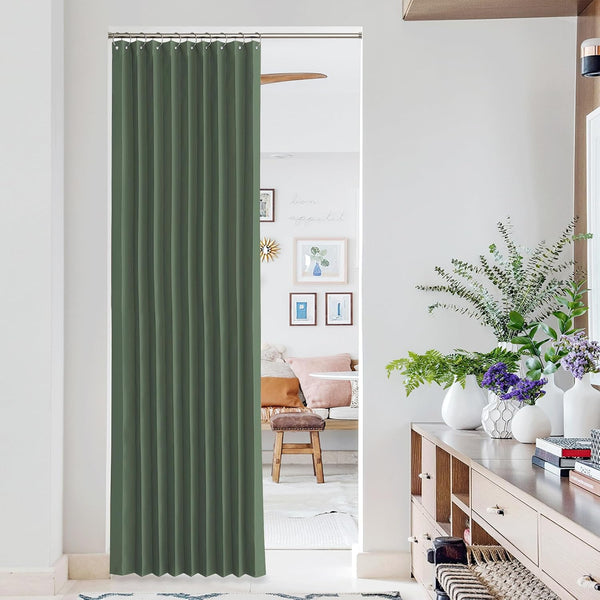 Sage green pleated room divider curtain with ring top hooks, offering privacy in a modern doorway.