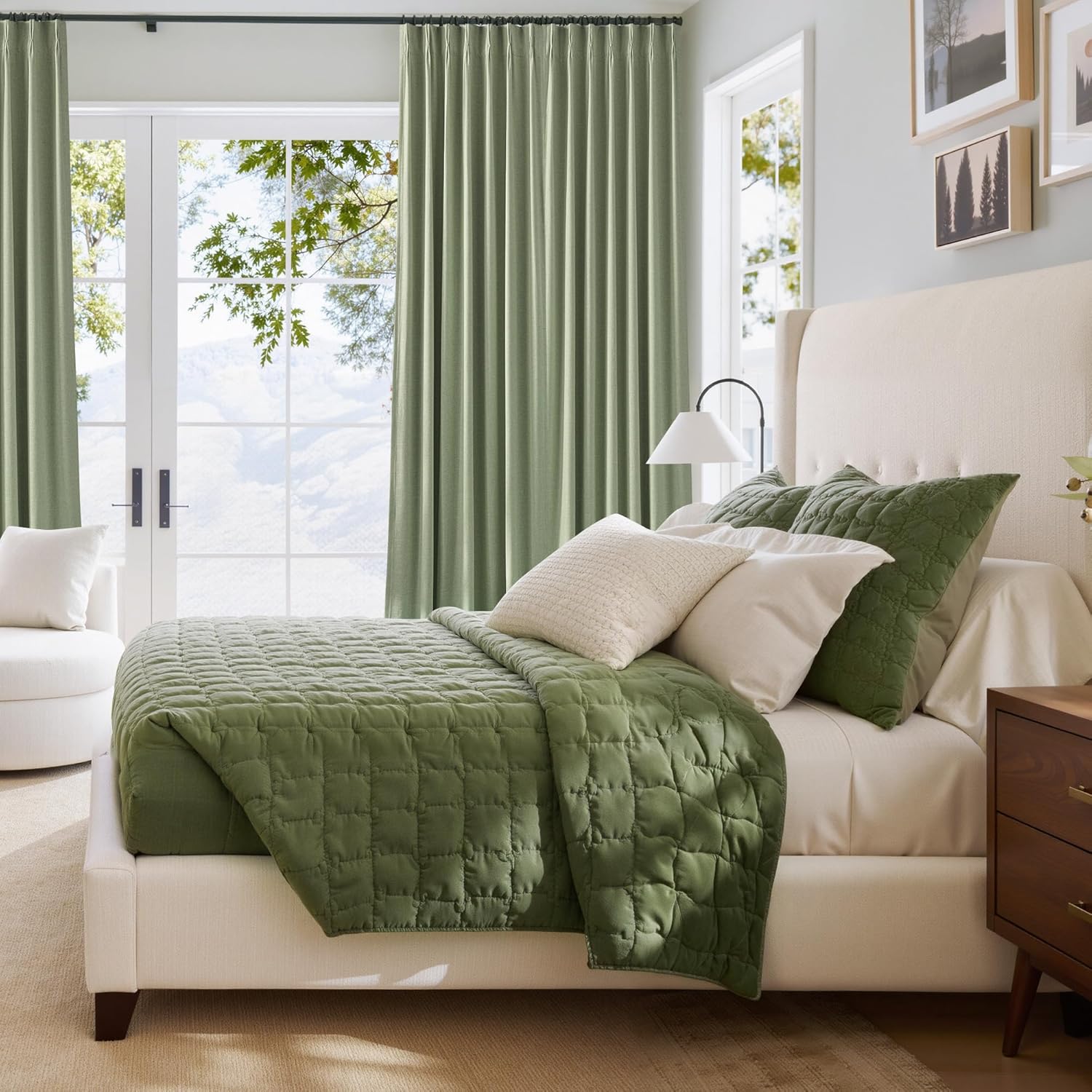 Sage green square quilted bedspread and matching pinch pleat curtains in a bright, modern bedroom.
