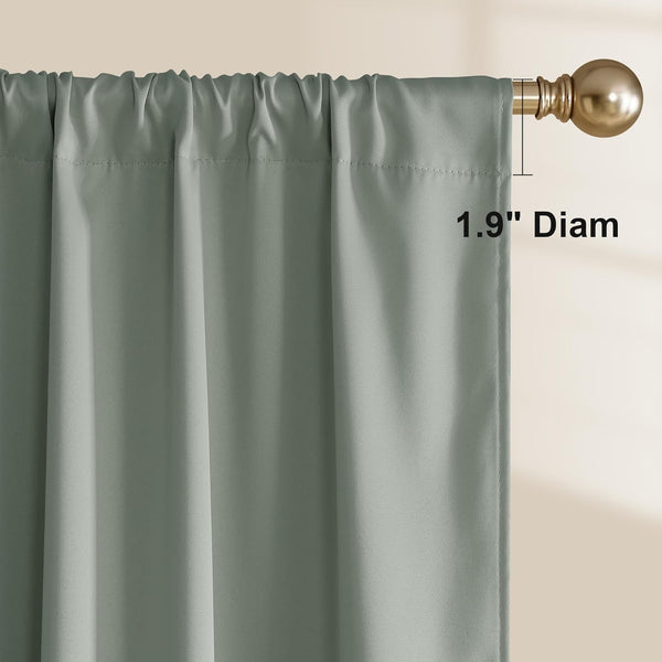 Close-up of a sage green rod pocket curtain panel with a gathered top, hanging on a golden decorative rod.