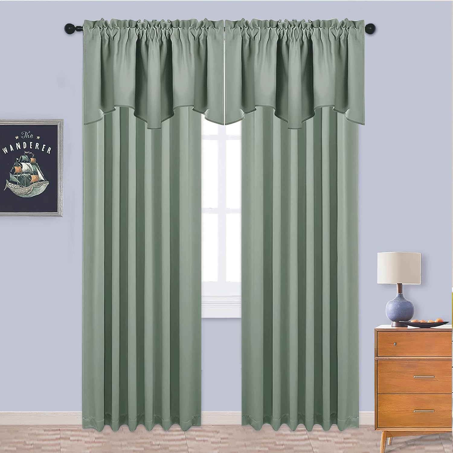 Two sage green rod pocket blackout curtains with a stylish attached scalloped valance over a window.