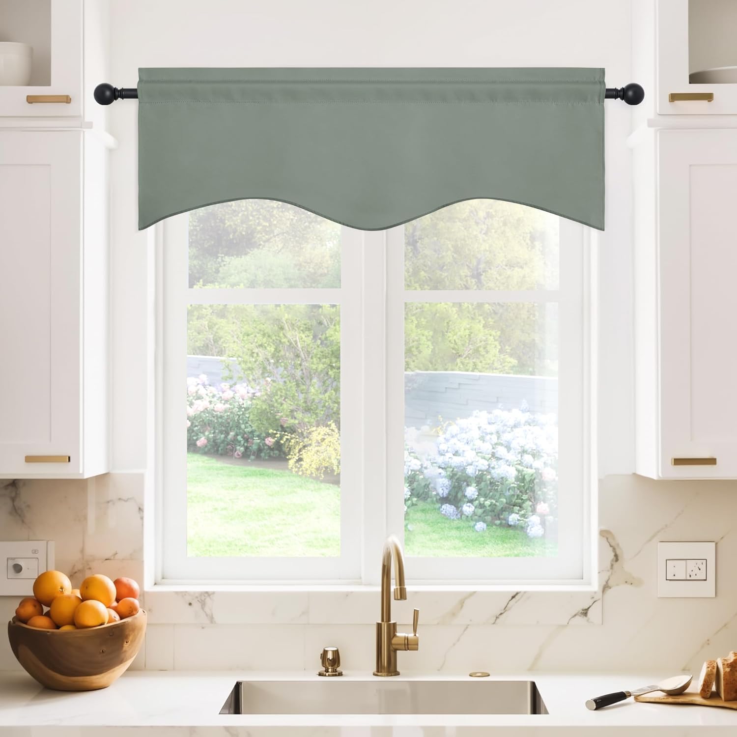 Sage green fabric valance with scalloped bottom edge, hung over a kitchen window.
