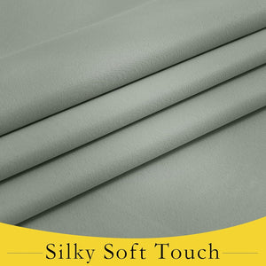Close-up of draped sage green fabric with a subtle, soft sheen and smooth, elegant texture.
