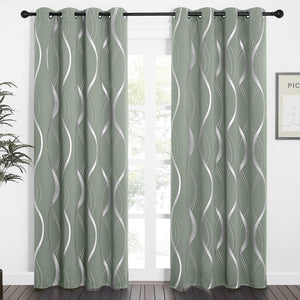 Pair of sage green curtains with silver metallic wavy pattern and grommet tops, hanging.