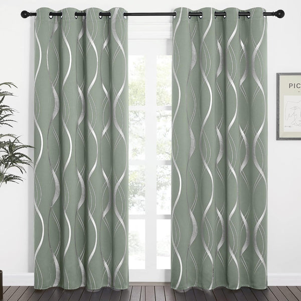Pair of sage green curtains with silver metallic wavy pattern and grommet tops, hanging.