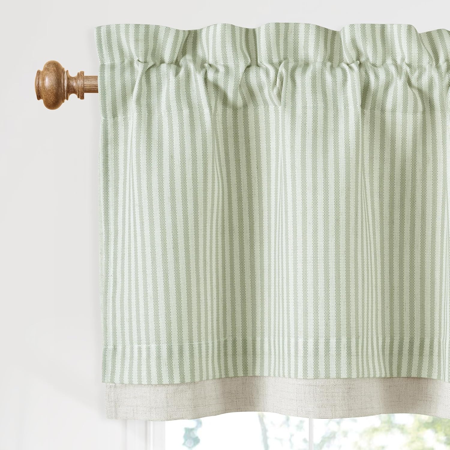 Sage green and white striped rod pocket valance with natural linen-look bottom hem on a wooden curtain rod.