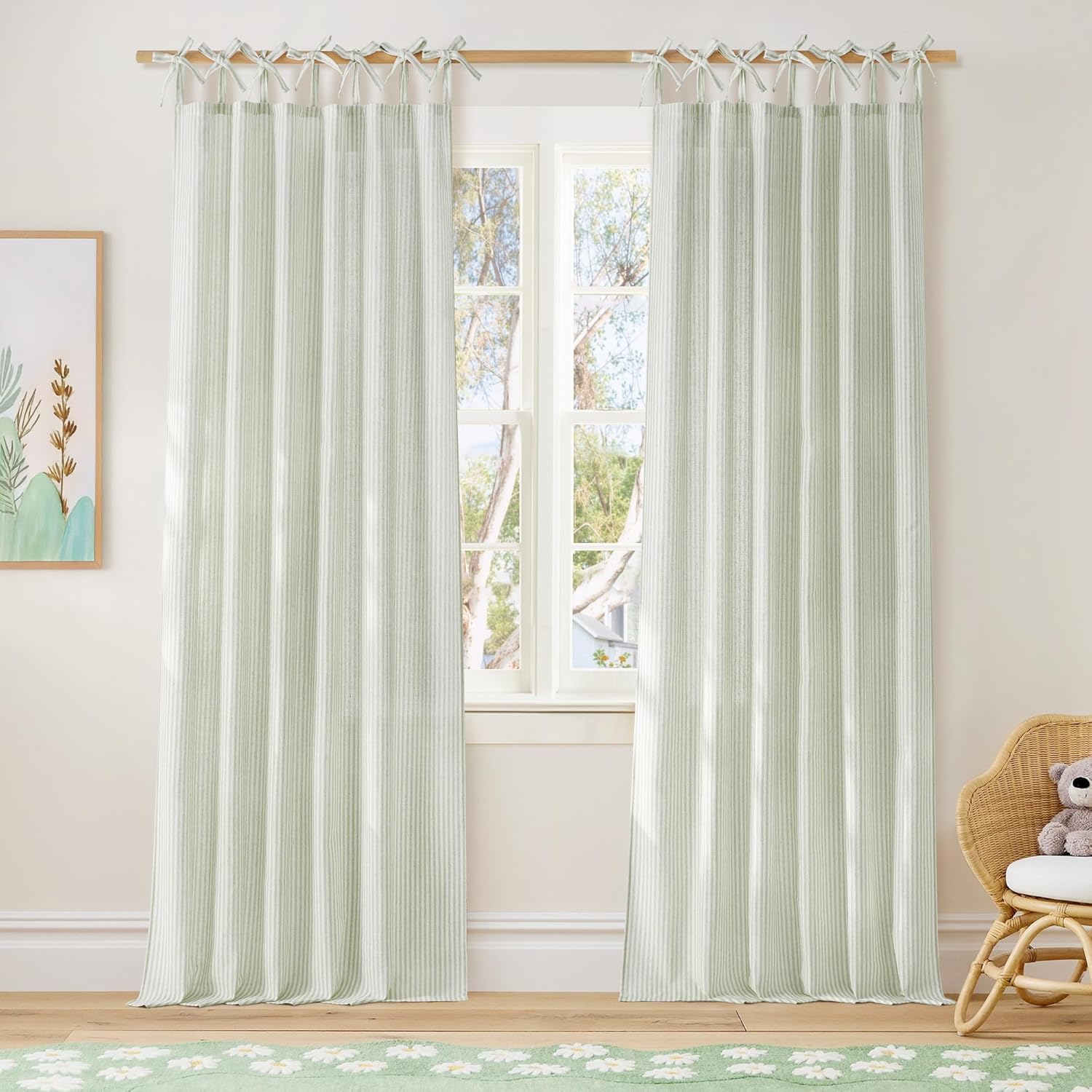 Sage green and white striped tie-top curtains on a wooden rod in a bright, airy room with natural light.