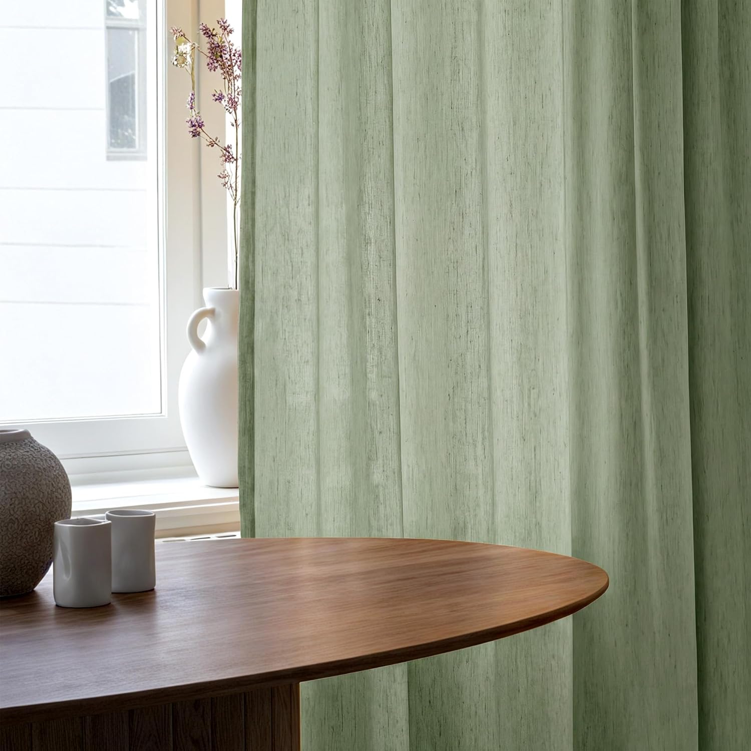 Textured sage green vertical blind panels filtering sunlight from a window. Modern home decor.