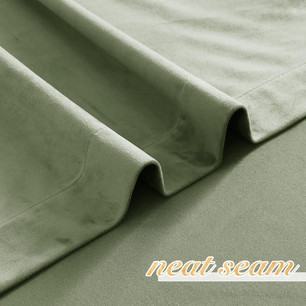 Close-up of soft, textured sage green velvet curtain fabric showing elegant folds and a neat seam.