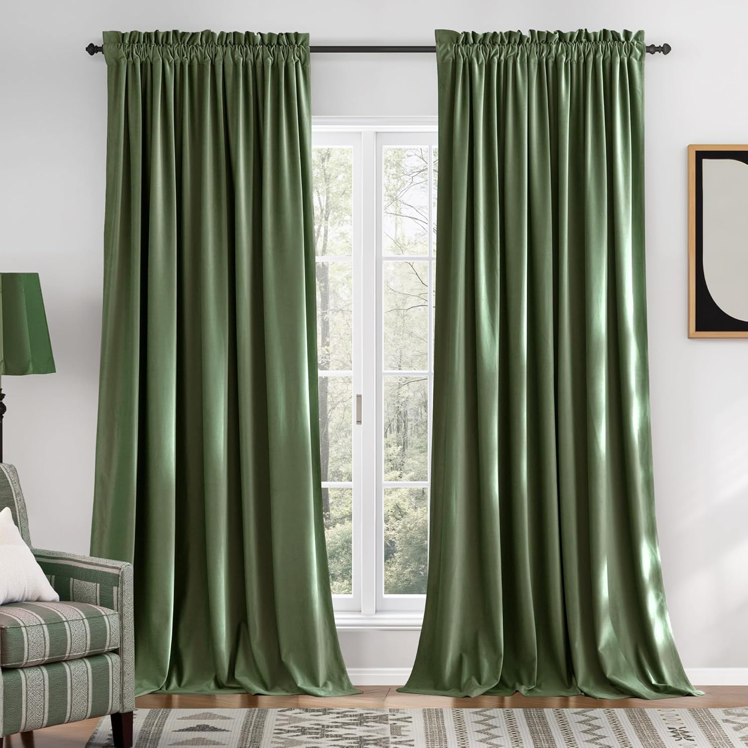Plush sage green velvet window curtains with a gathered top beautifully framing a white window.