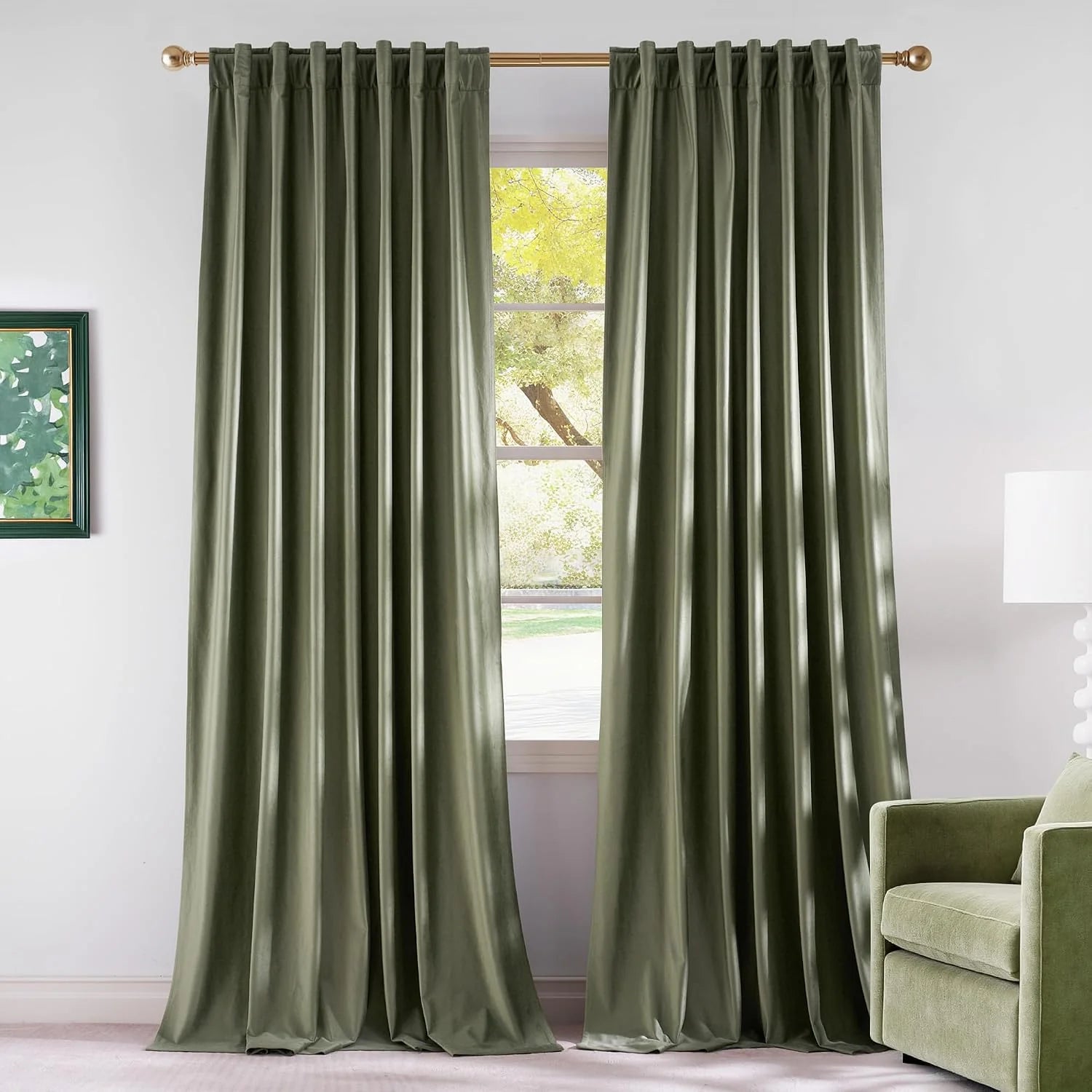 Sage green velvet curtains with rod pocket header hanging on a brass curtain rod