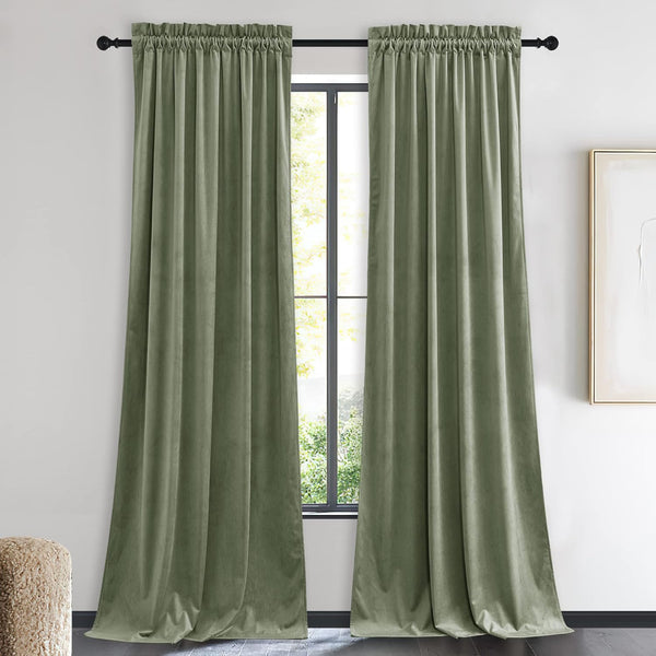 Pair of sage green velvet curtains with rod pocket top, hanging elegantly on a black rod.