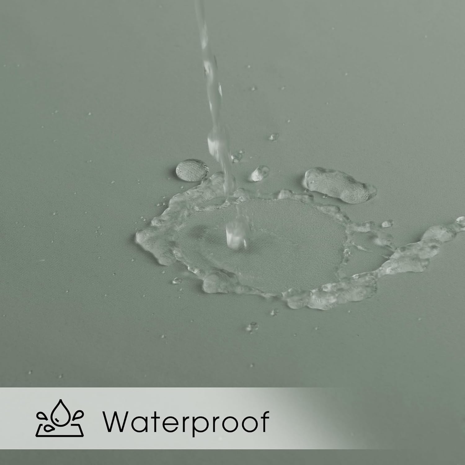 Water streams onto a sage green fabric surface, beading up to show its waterproof quality.