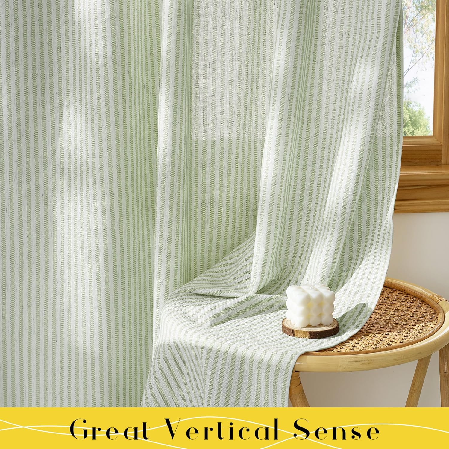 Sage green and white vertical striped woven curtains hanging in a sunny room, draped over a rattan stool.
