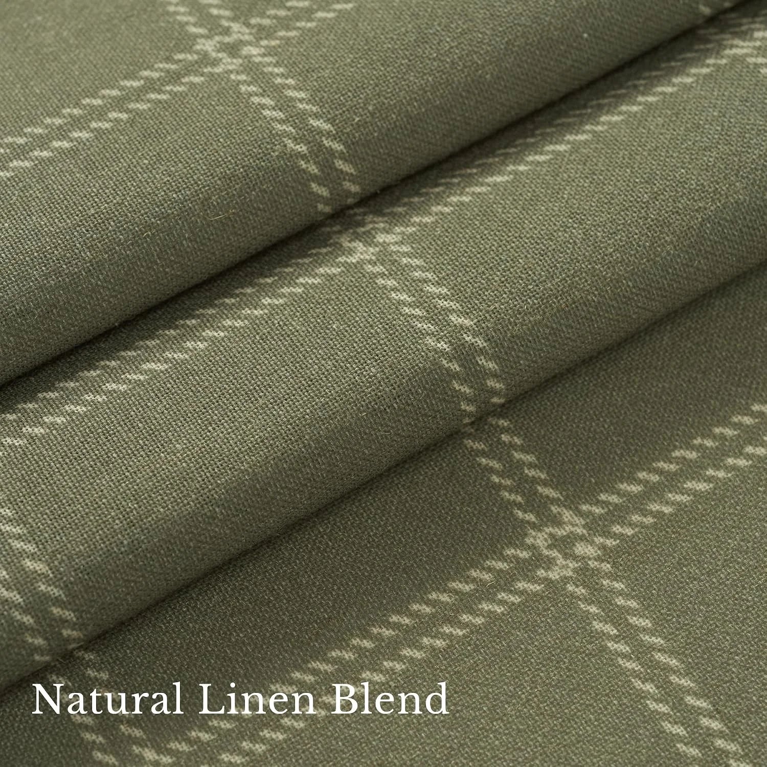 Close-up of sage green linen blend fabric with a soft white windowpane plaid pattern