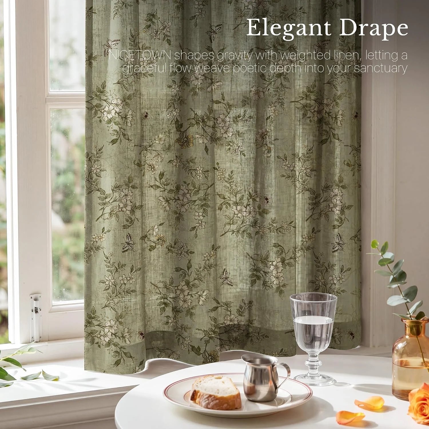 Sage green linen curtain with delicate floral print hanging by a bright window