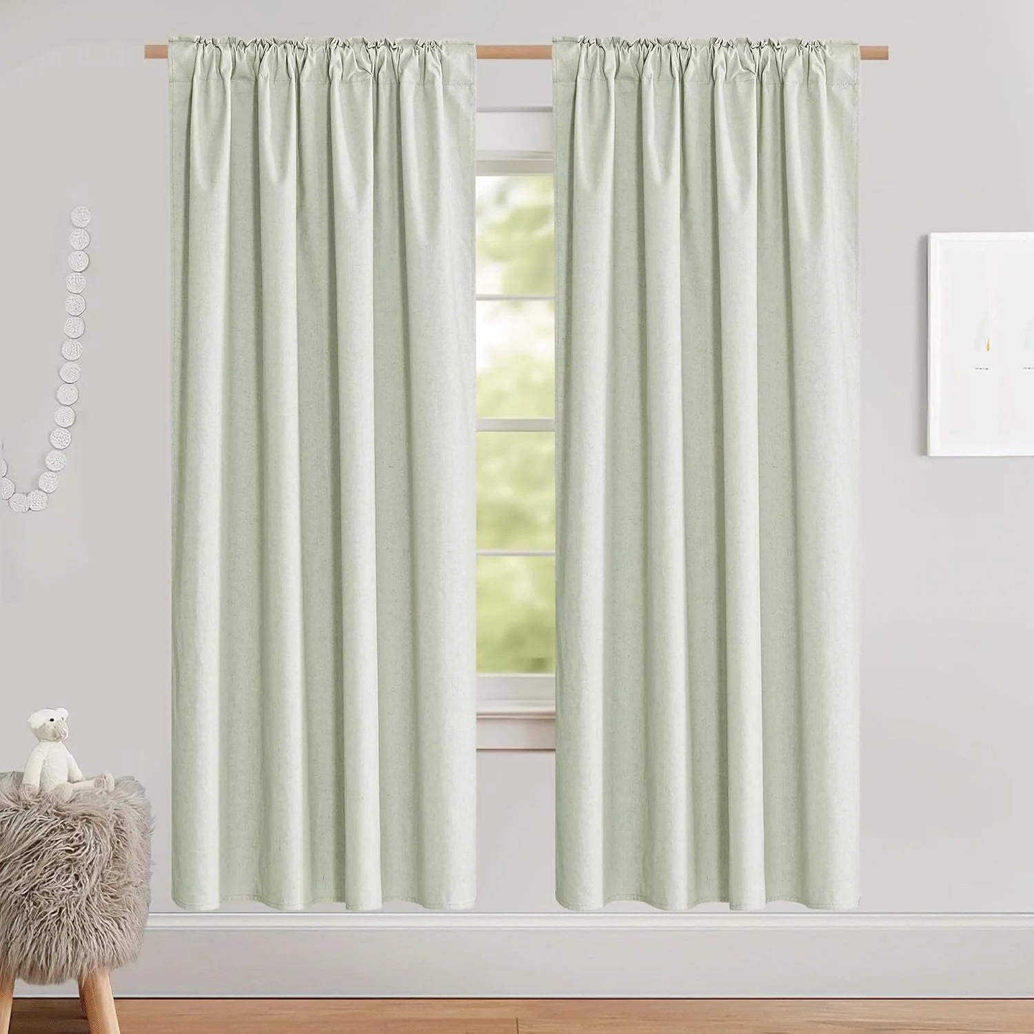 Light sage linen-look rod pocket curtains hanging in a soft neutral room