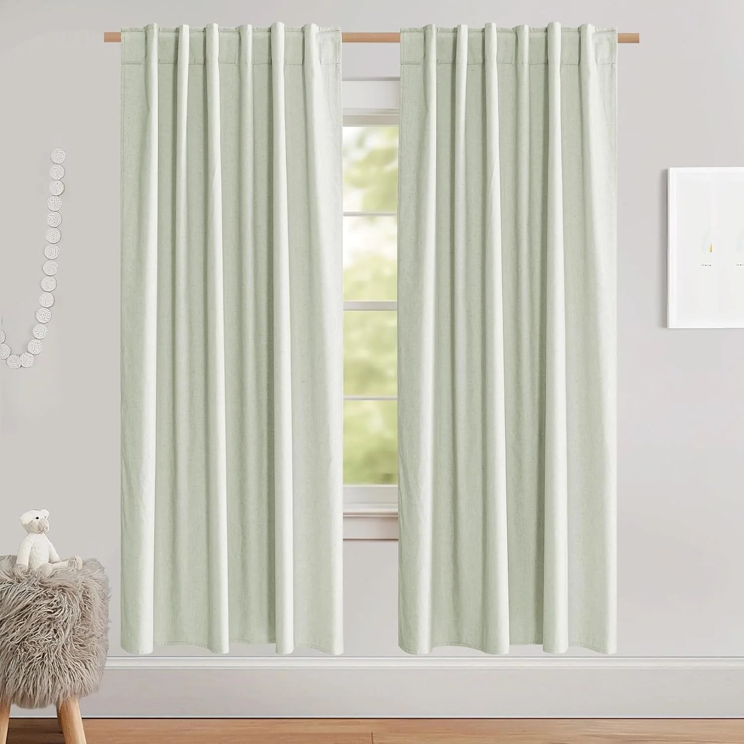 Soft sage green linen-look rod pocket curtains hanging in a bright minimalist room
