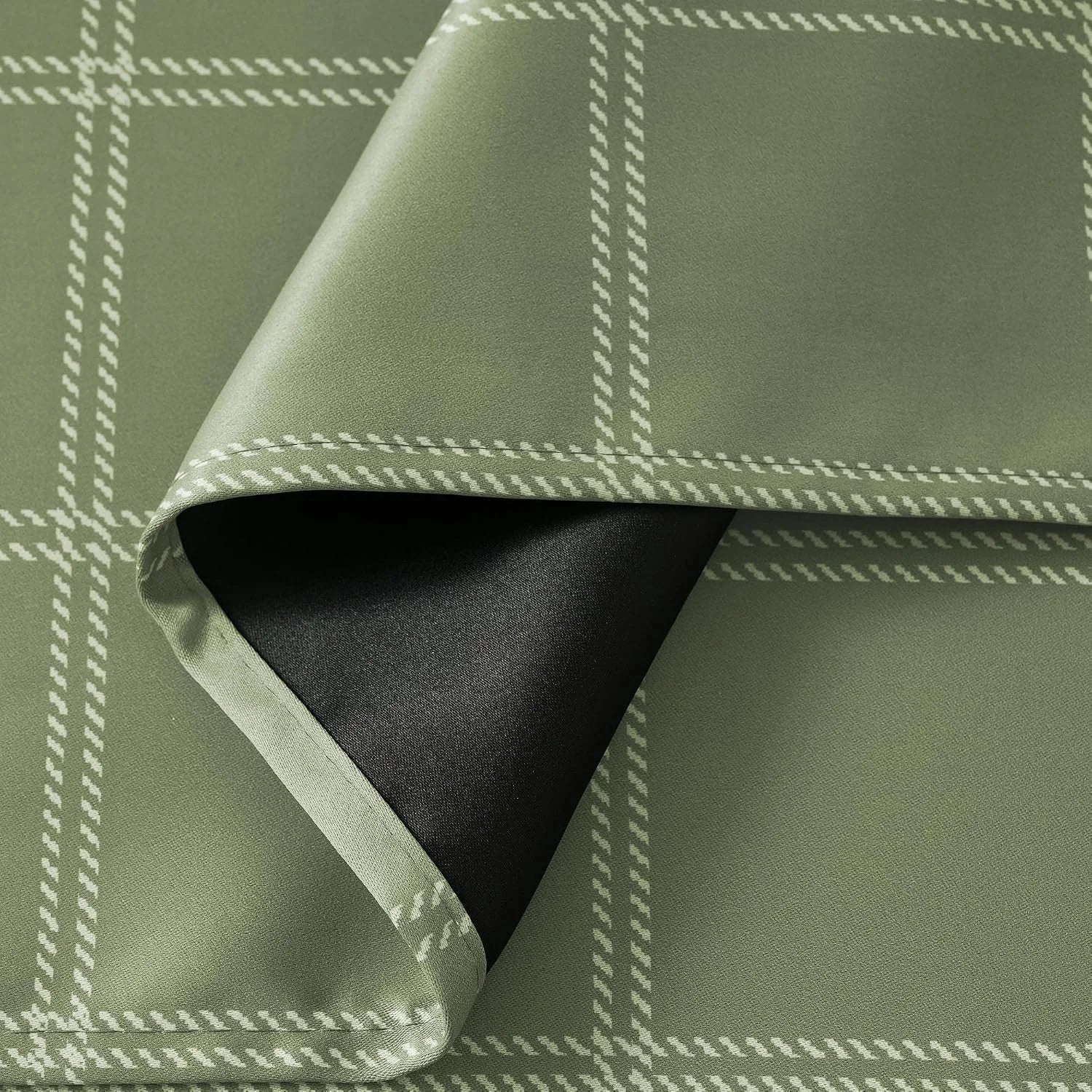 Sage green plaid curtain fabric with white grid pattern and black blackout backing
