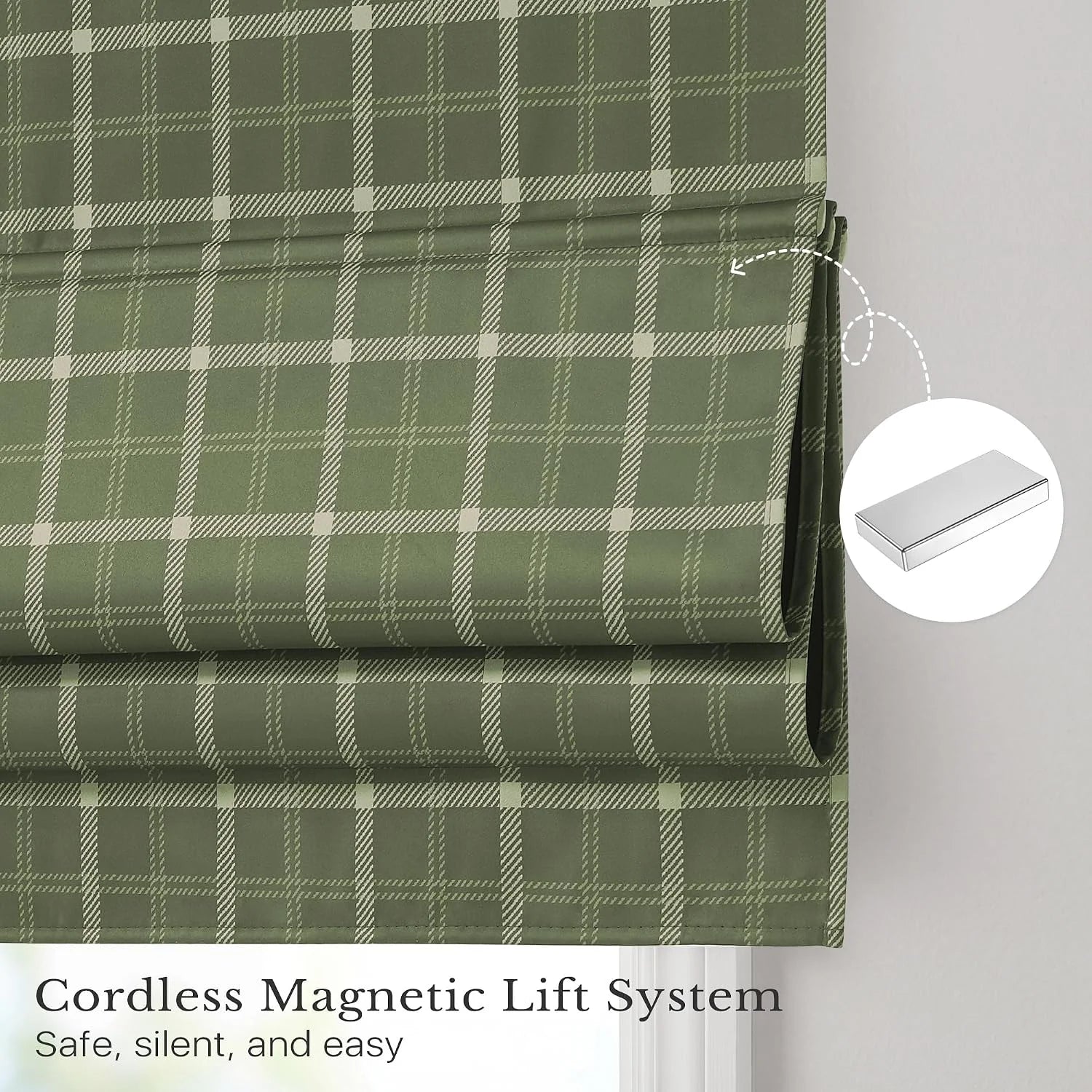 Sage green plaid cordless Roman shade with magnetic lift detail on a window
