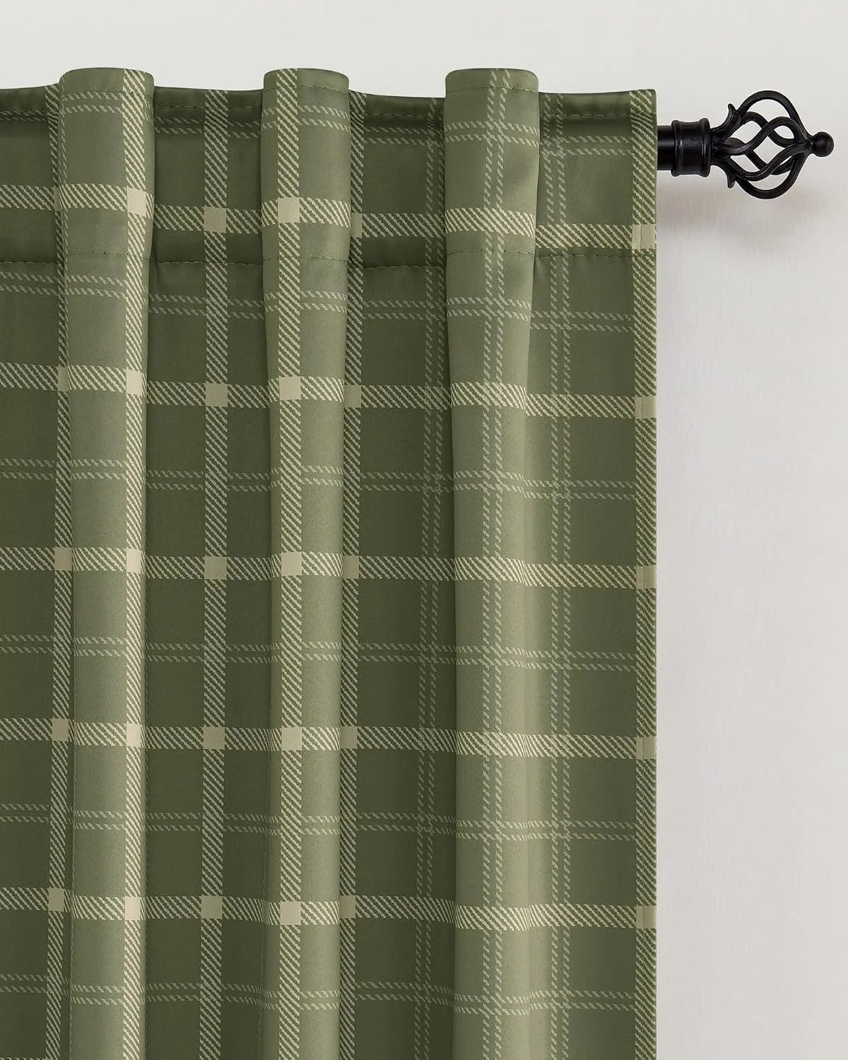 Sage green plaid curtain panel with rod pocket top on a black decorative curtain rod