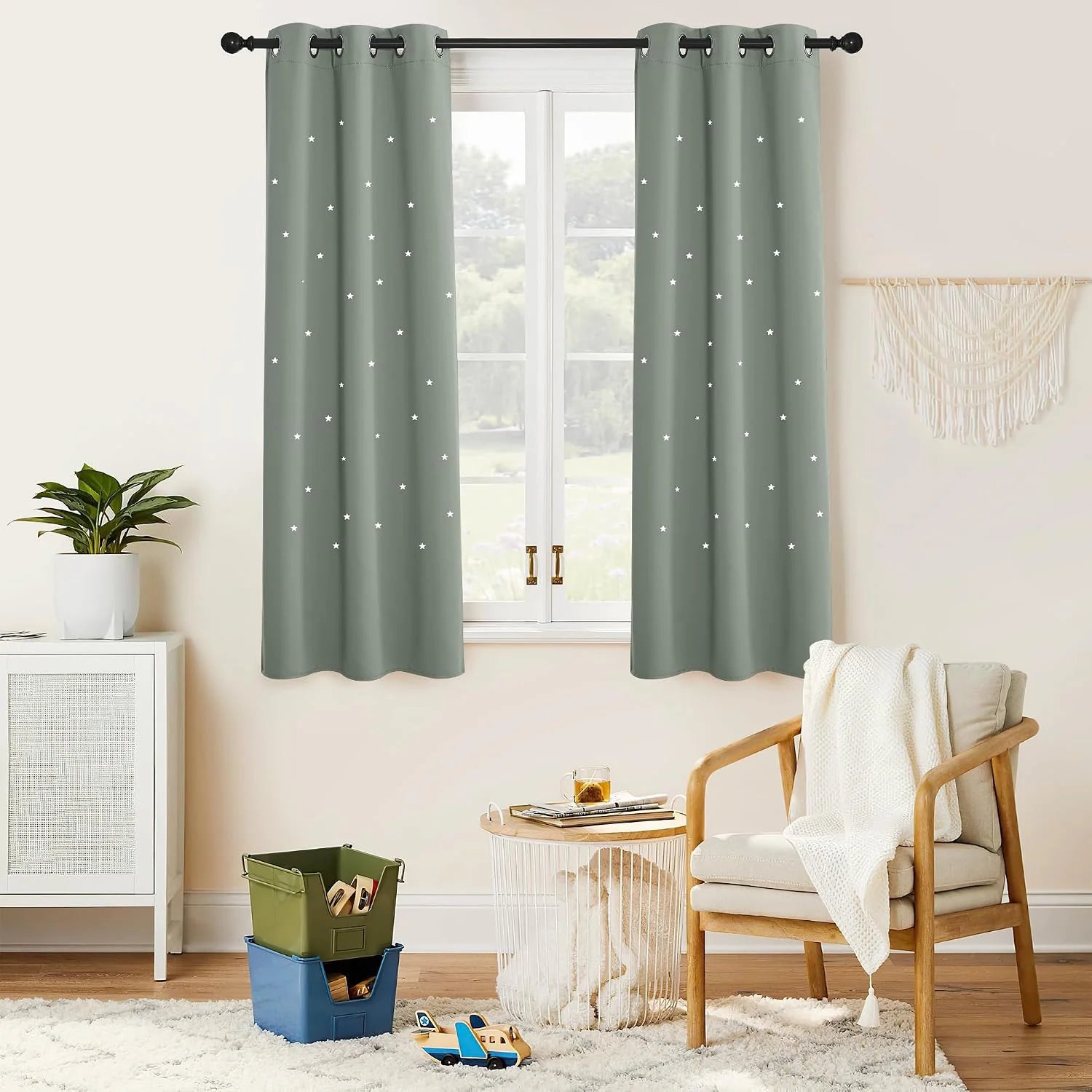 Sage green star blackout curtains with black grommets in a cozy kids room