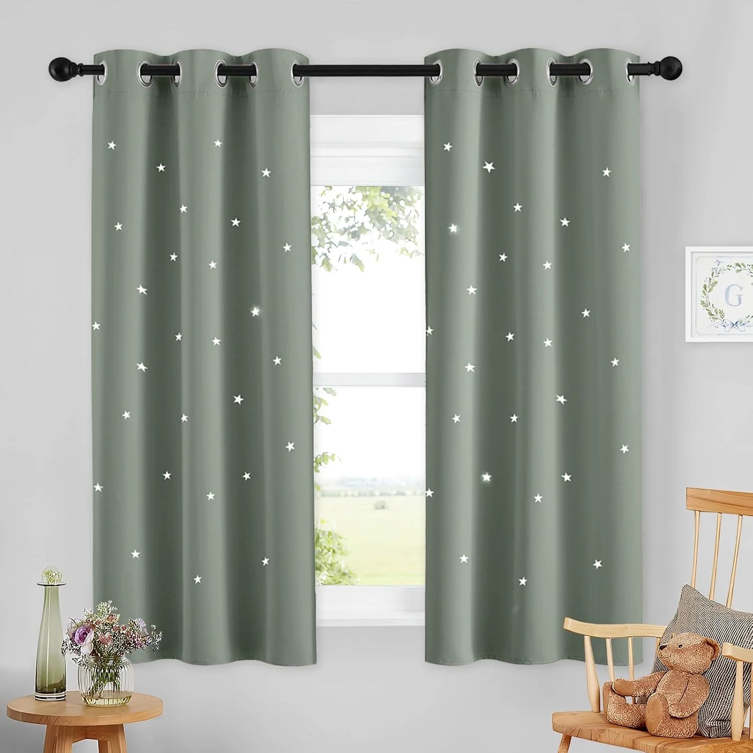 Sage green star cutout curtains with silver grommets in a light kids room