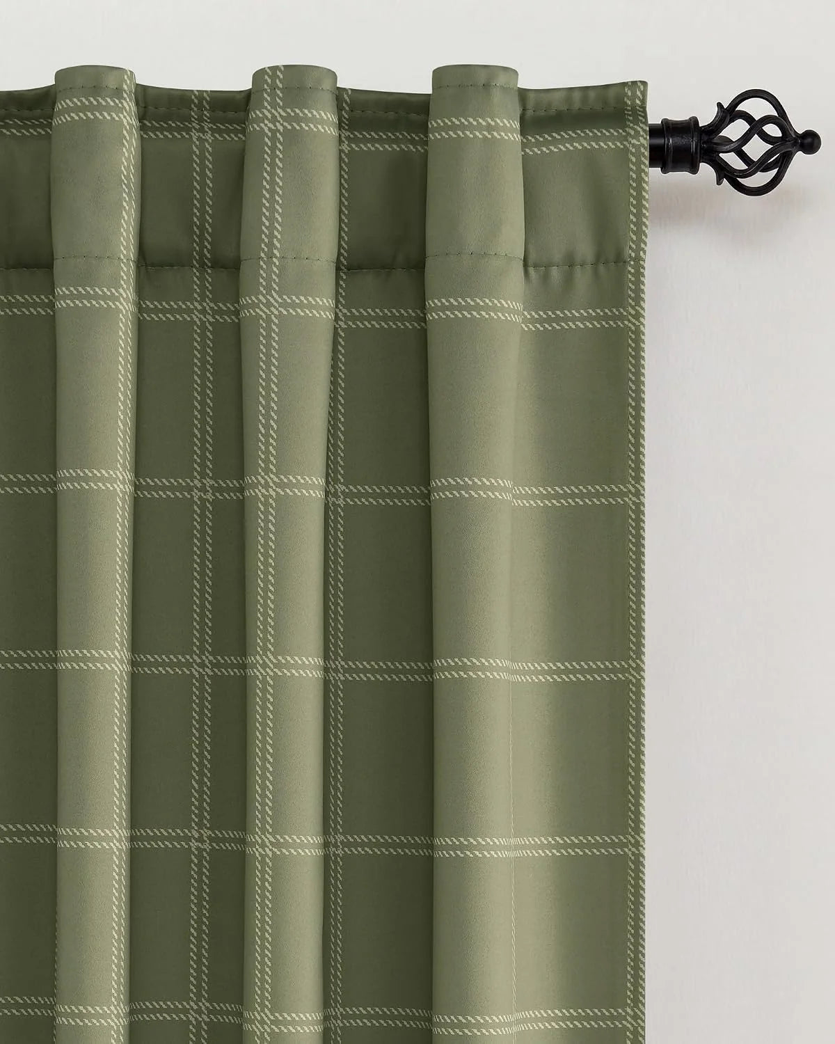 Sage green windowpane curtain panel with rod pocket hanging on black curtain rod