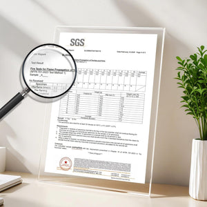 Close-up of an SGS fire safety test report for textiles, showing NFPA 701-2023 compliance, held in a clear acrylic display, with a magnifying glass.