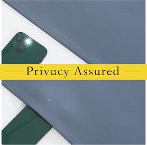 Slate blue textured fabric swatch with a green phone flashlight underneath, showing its light-blocking privacy.