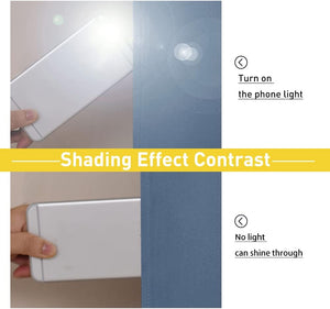 Demonstration of slate blue blackout fabric. Top: phone light on; bottom: no light penetrates.