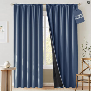 Slate blue 100% blackout curtains with gathered rod pocket top, one panel open revealing black lining.