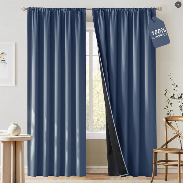 Slate blue 100% blackout curtains with gathered rod pocket top, one panel open revealing black lining.