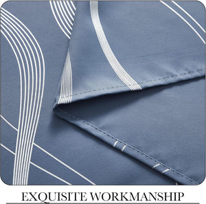 Close-up of slate blue curtain fabric with modern white geometric lines and visible neat stitching.