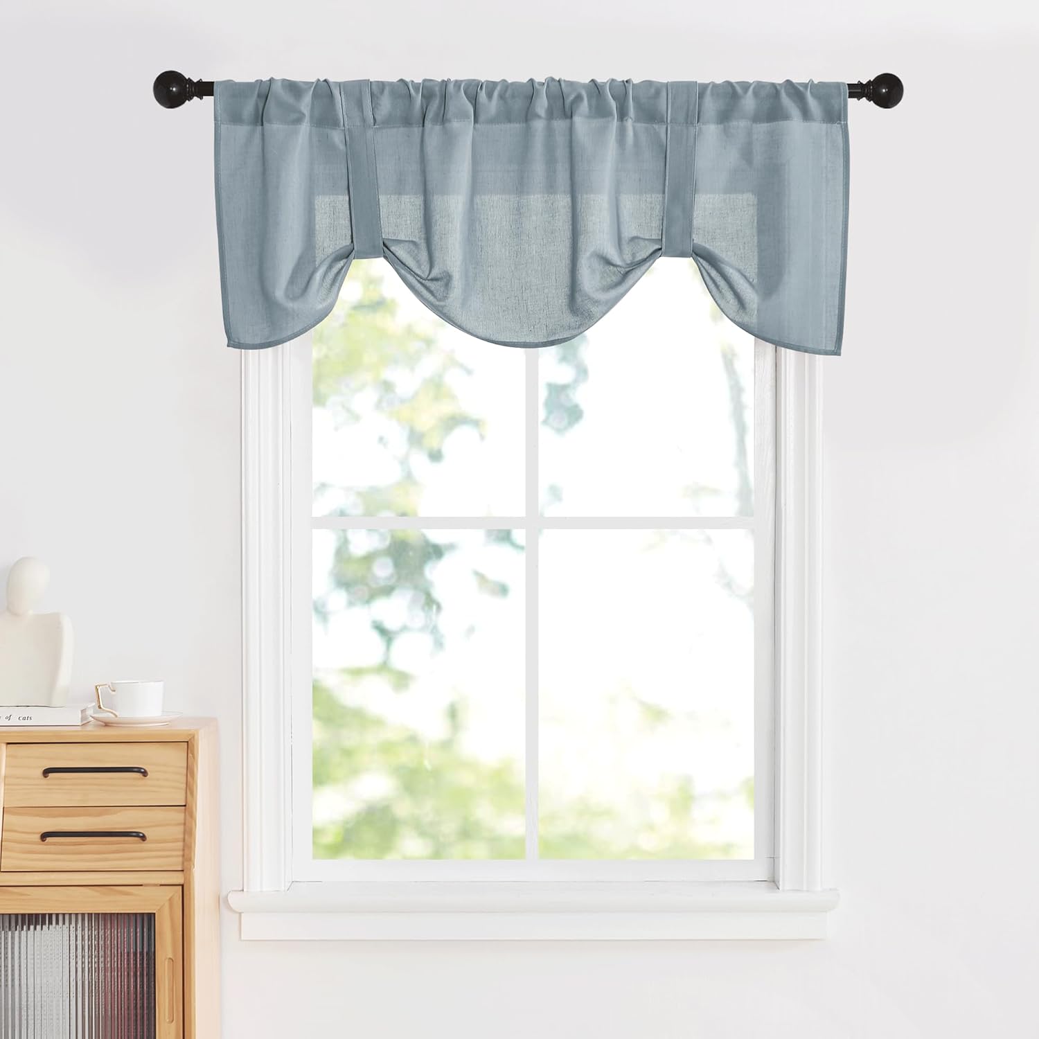 Dusty blue textured tie-up window valance with gathered rod pocket and scalloped bottom.