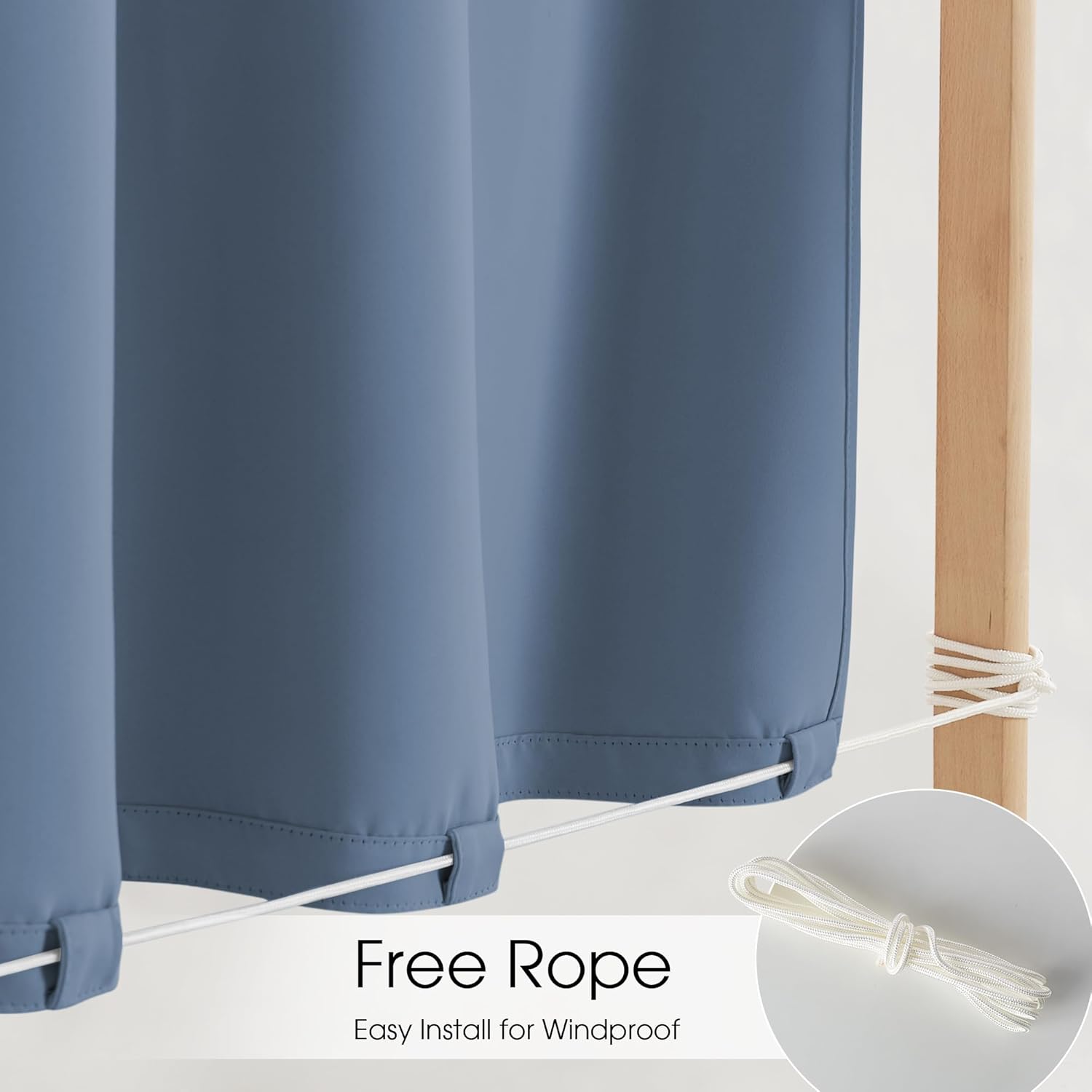 Slate blue outdoor curtains, bottom loops with white rope for windproof stability, tied to a wooden post.