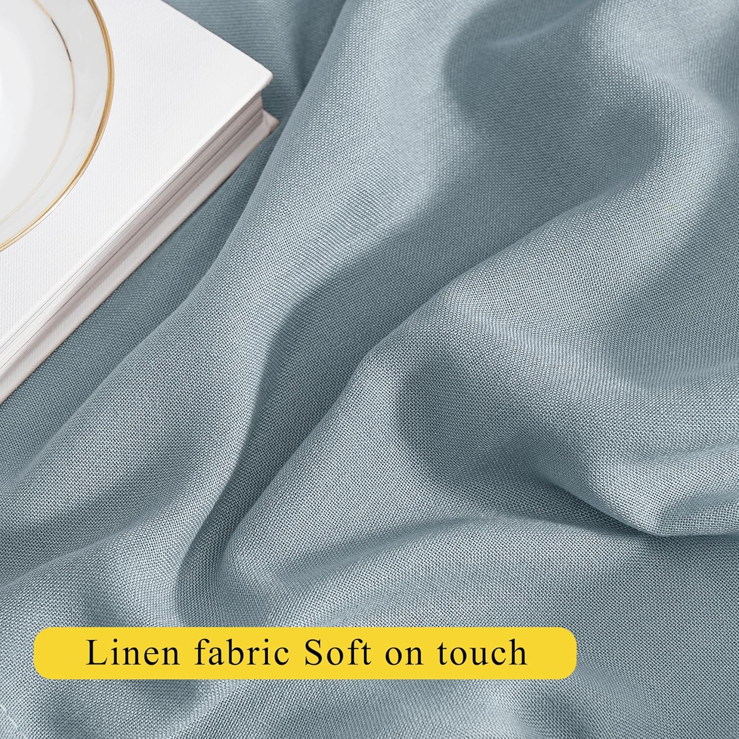 Close-up of soft light blue linen fabric draped, highlighting its fine texture and natural weave.