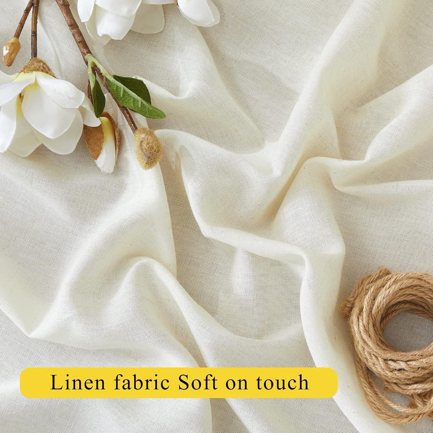 Soft cream linen fabric with natural texture. White magnolia flowers and coiled jute rope.