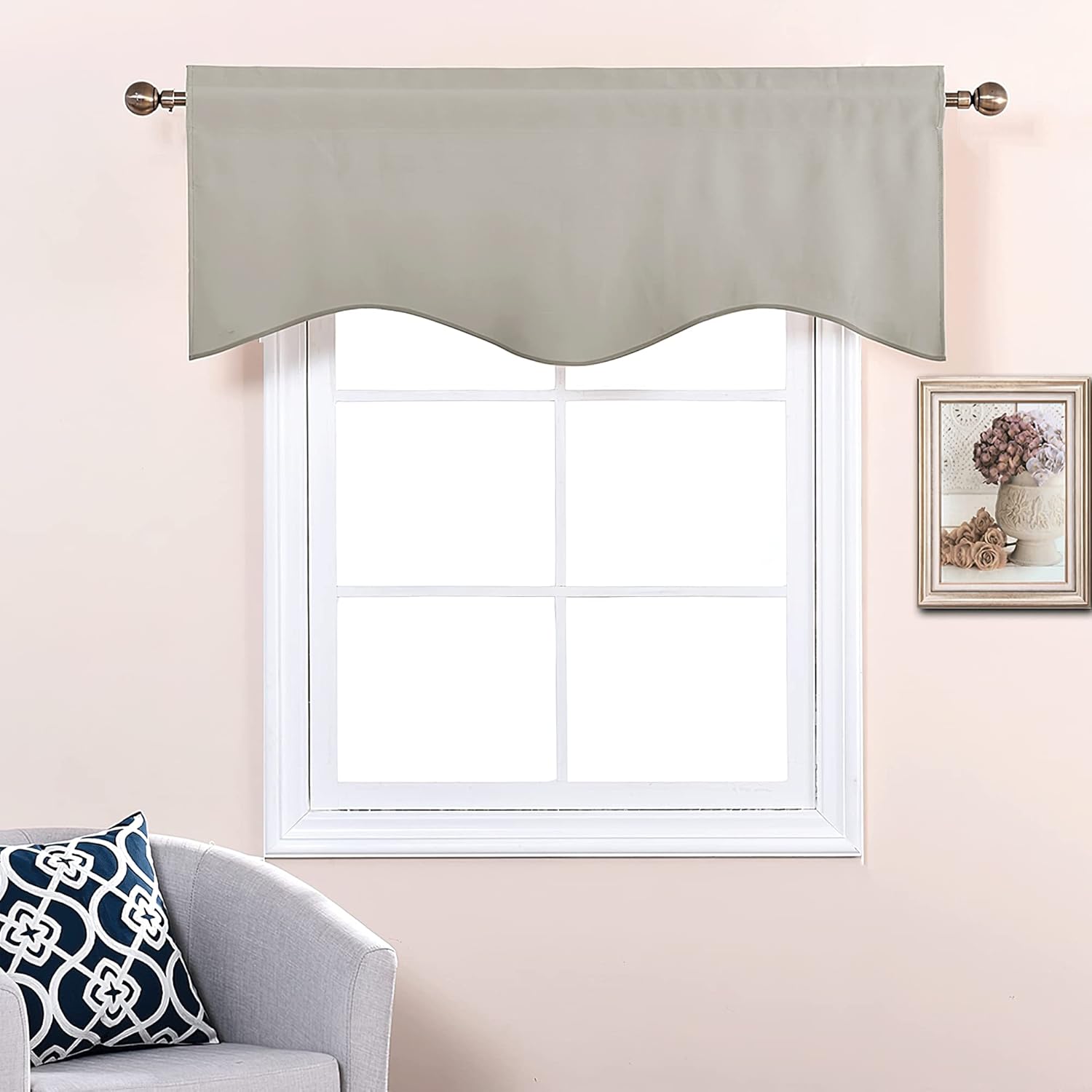 Light grey scalloped valance with rod pocket design, hanging on a bronze curtain rod above a white window.
