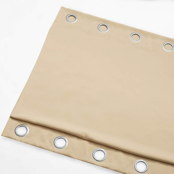 Tan blackout curtain panel with multiple silver metal grommets, folded neatly.