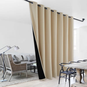 Tan grommet room divider blackout curtain, ceiling mounted to separate living and dining areas.